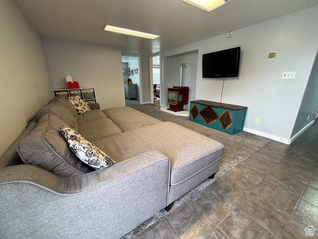 Living area featuring a wood stove and baseboards