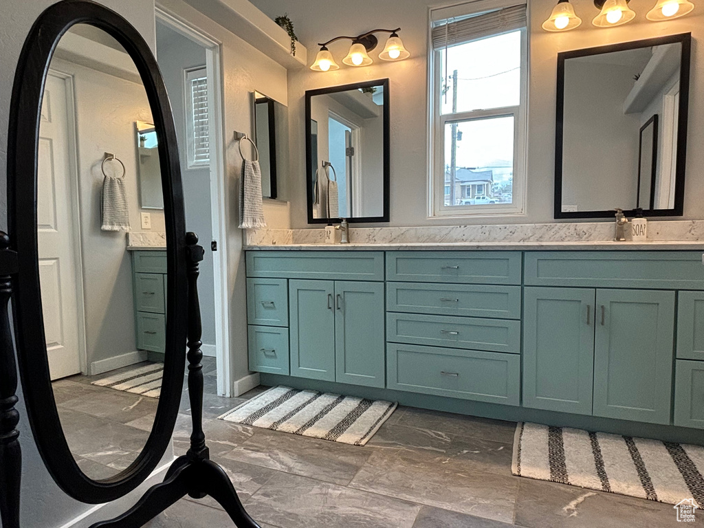 Full bathroom with marble look tile flooring and double vanity