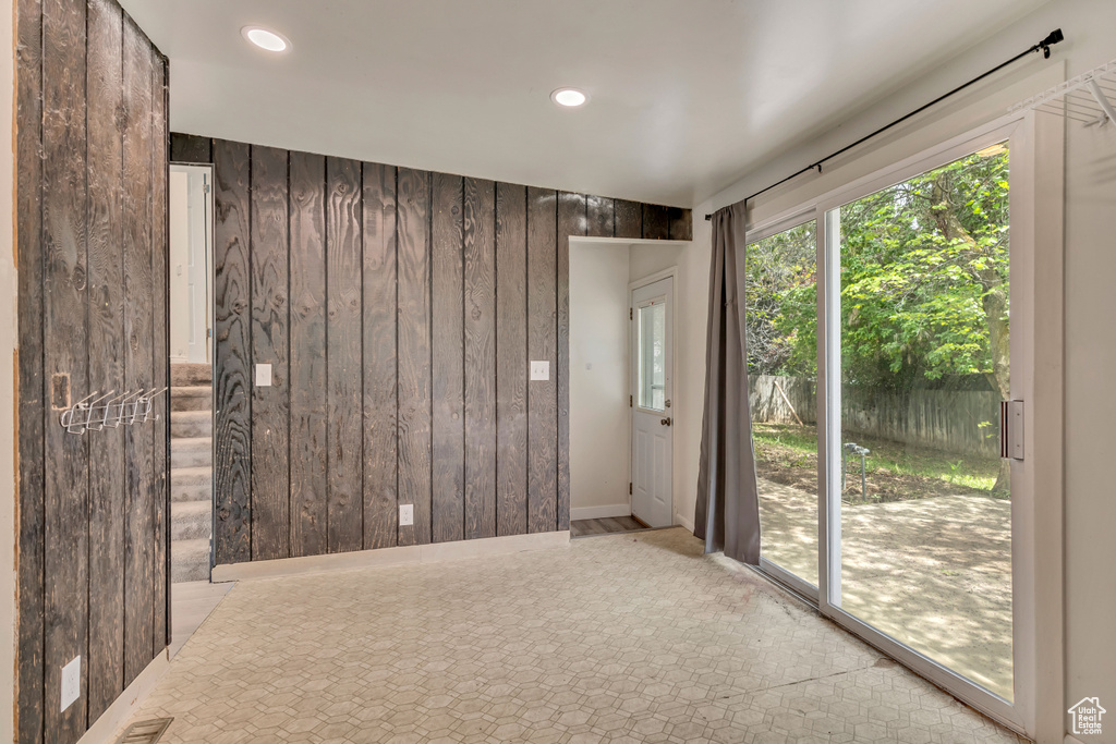 Empty room with wood walls and recessed lighting