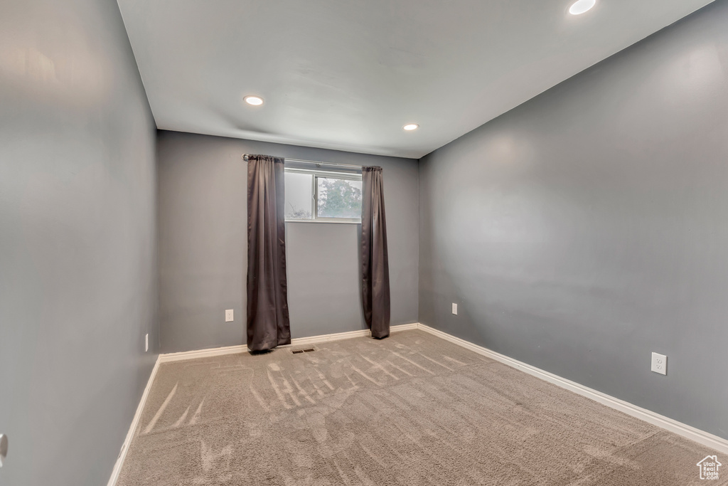 Spare room with light colored carpet, recessed lighting, and baseboards