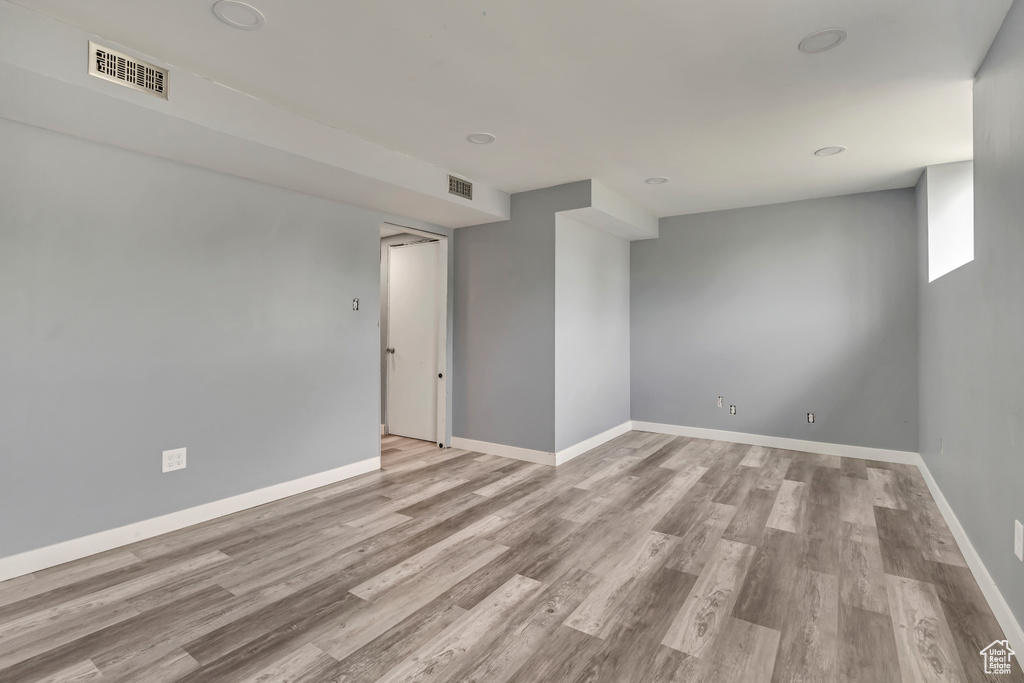 Unfurnished room featuring wood finished floors and baseboards