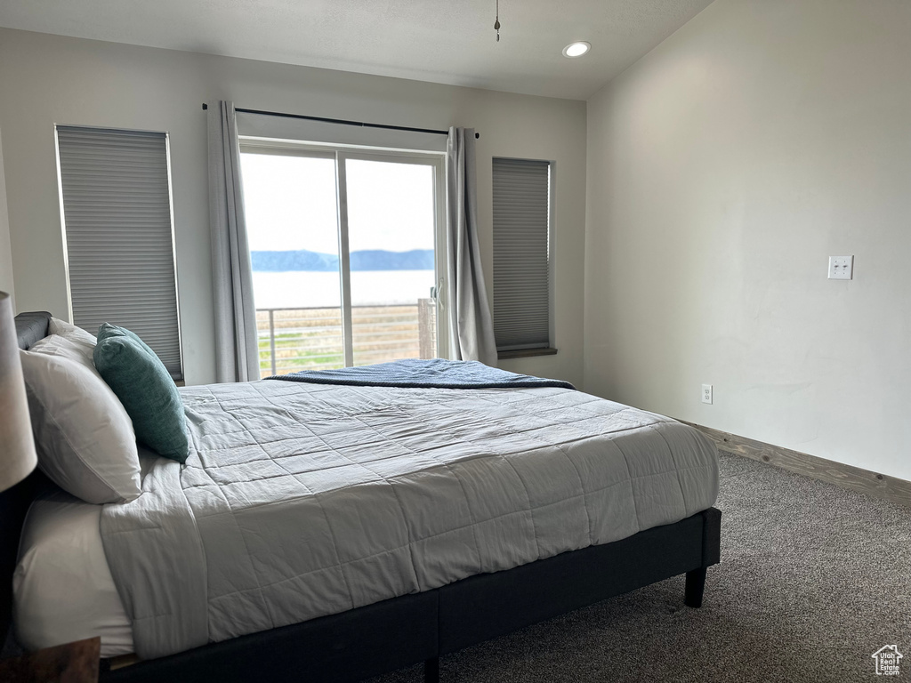 Carpeted bedroom featuring baseboards, recessed lighting, and a mountain view