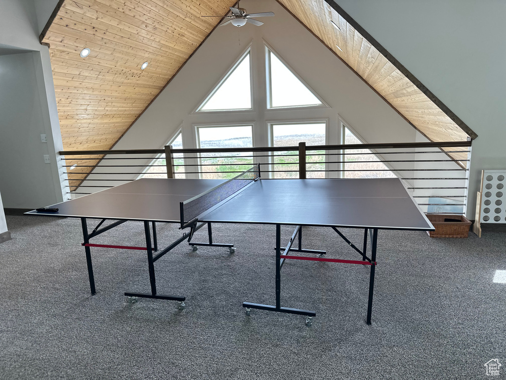 Rec room featuring ceiling fan, wooden ceiling, carpet flooring, and lofted ceiling