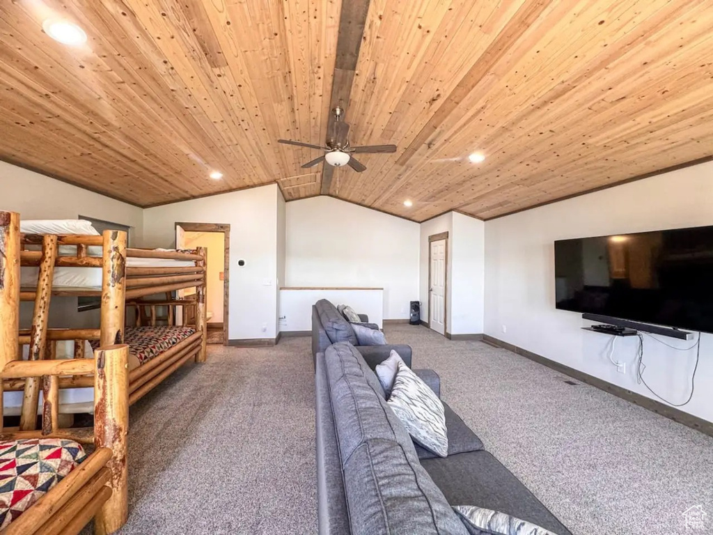 Carpeted bedroom with vaulted ceiling, recessed lighting, baseboards, and wooden ceiling