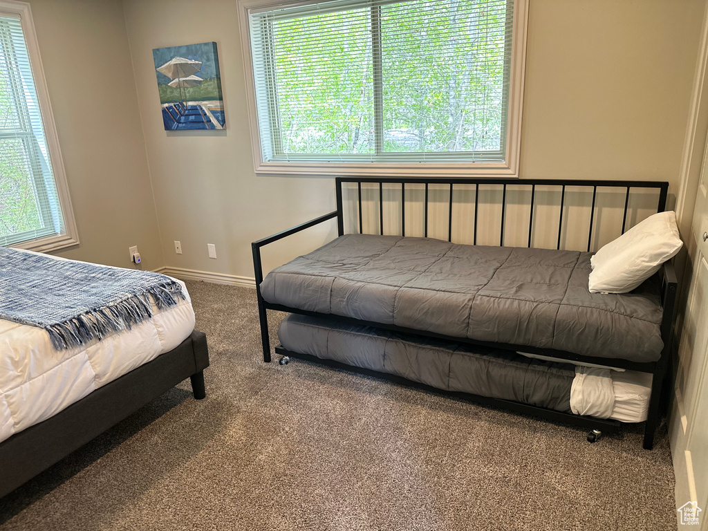 Bedroom with carpet floors and baseboards