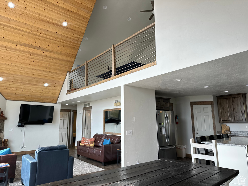 Living room with high vaulted ceiling, wooden ceiling, recessed lighting, a ceiling fan, and wood finished floors