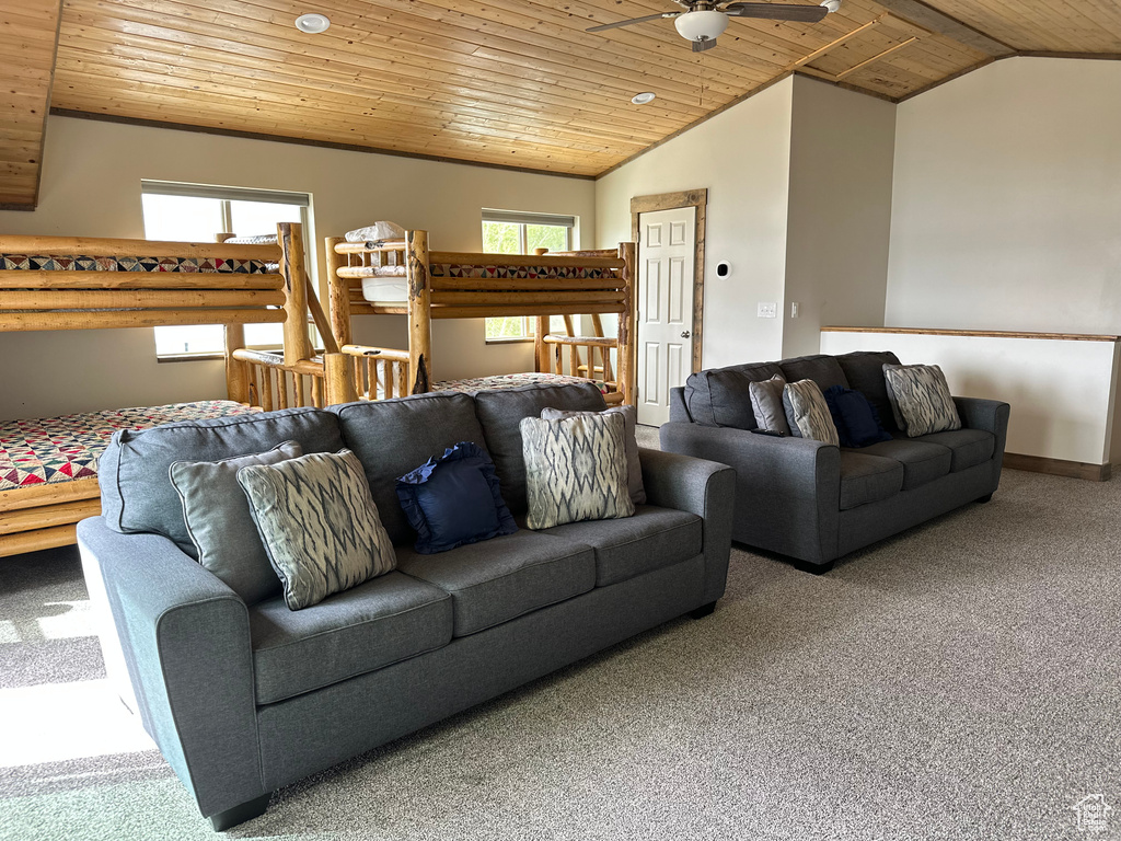 Carpeted living room with wooden ceiling, lofted ceiling, and a ceiling fan