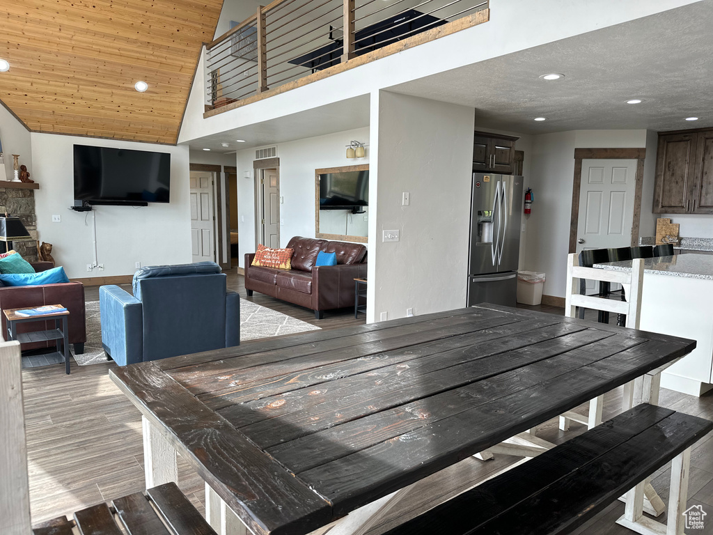 Dining area featuring recessed lighting, light wood-style flooring, and high vaulted ceiling