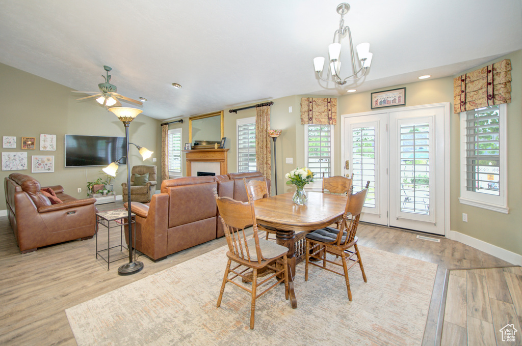 Dining space with wood finished floors, baseboards, ceiling fan, recessed lighting, and a chandelier