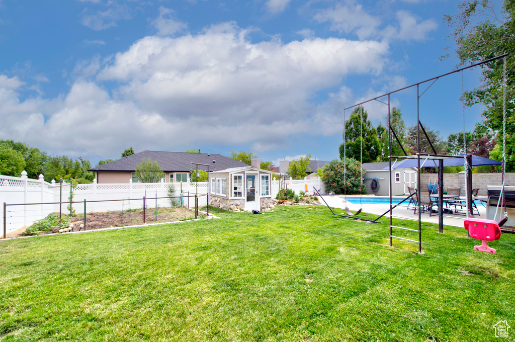 View of yard with an outbuilding, a garden, and a patio area