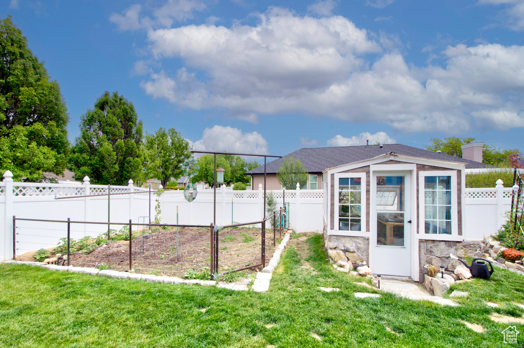 View of yard with a garden and an outdoor structure
