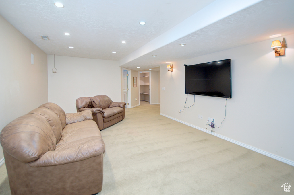 Living room featuring recessed lighting, light colored carpet, and baseboards