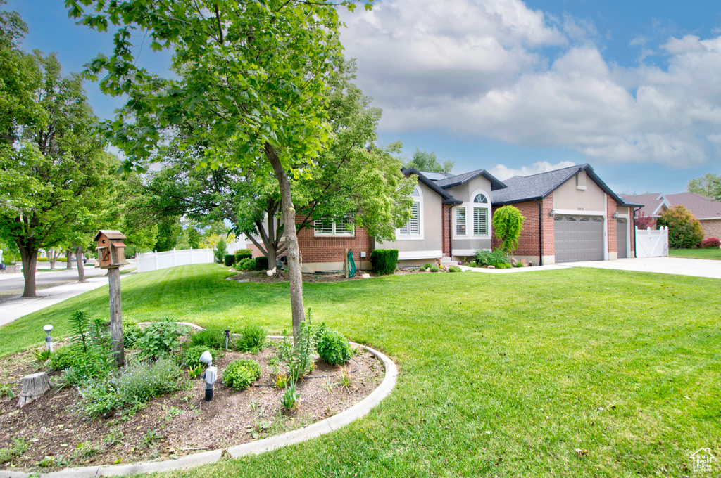 View of front of house with brick siding, a garage, and concrete driveway