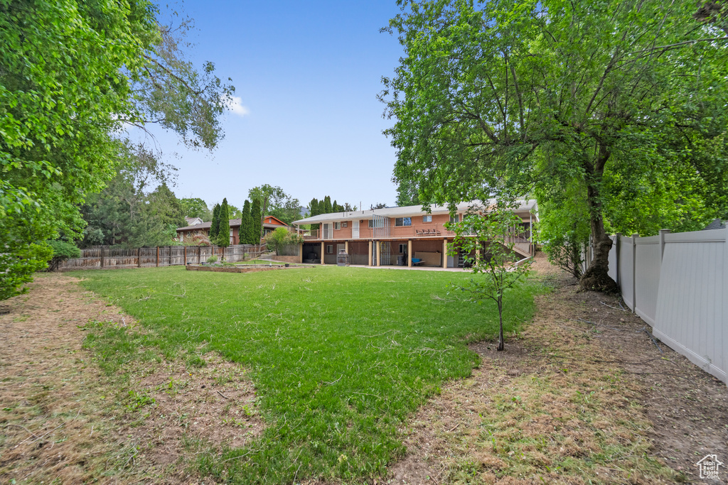 View of yard with a wooden deck