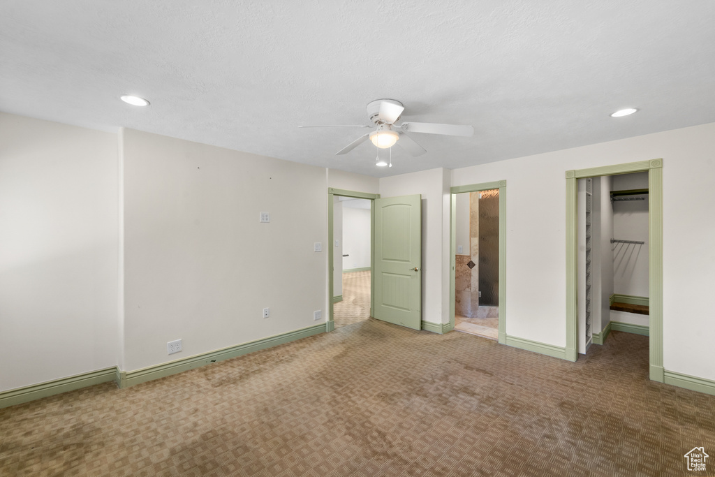 Unfurnished bedroom with recessed lighting, carpet flooring, baseboards, ensuite bathroom, and a ceiling fan