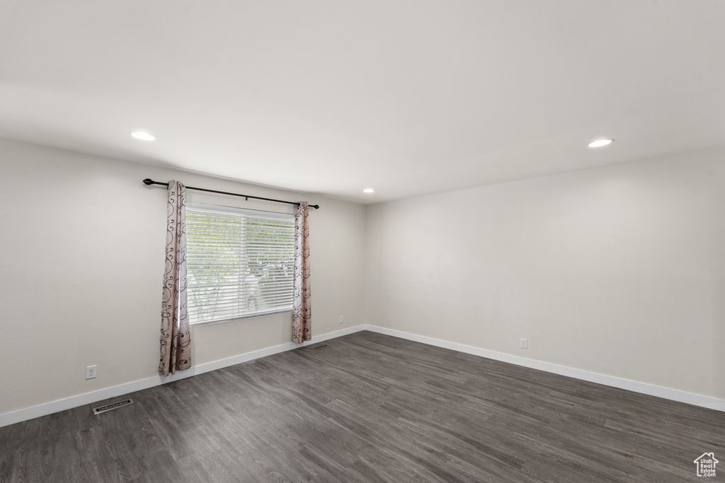 Spare room with dark wood finished floors, recessed lighting, and baseboards