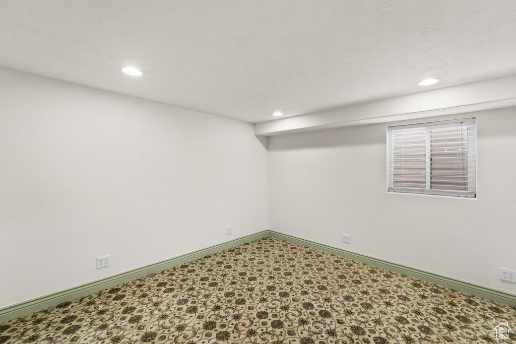 Below grade area with recessed lighting, baseboards, and tile patterned floors
