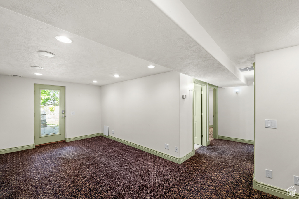Unfurnished room featuring baseboards, recessed lighting, carpet flooring, and a textured ceiling