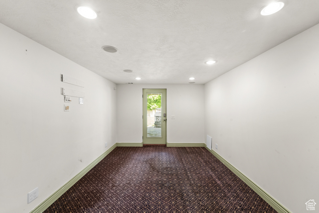 Spare room featuring recessed lighting, baseboards, and carpet flooring