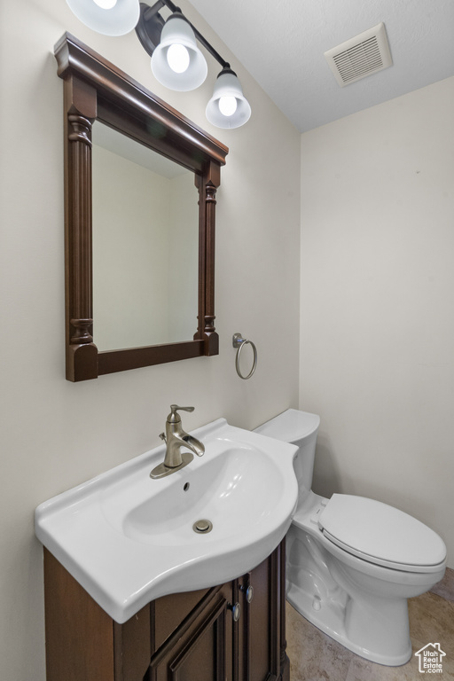 Half bath featuring toilet and vanity