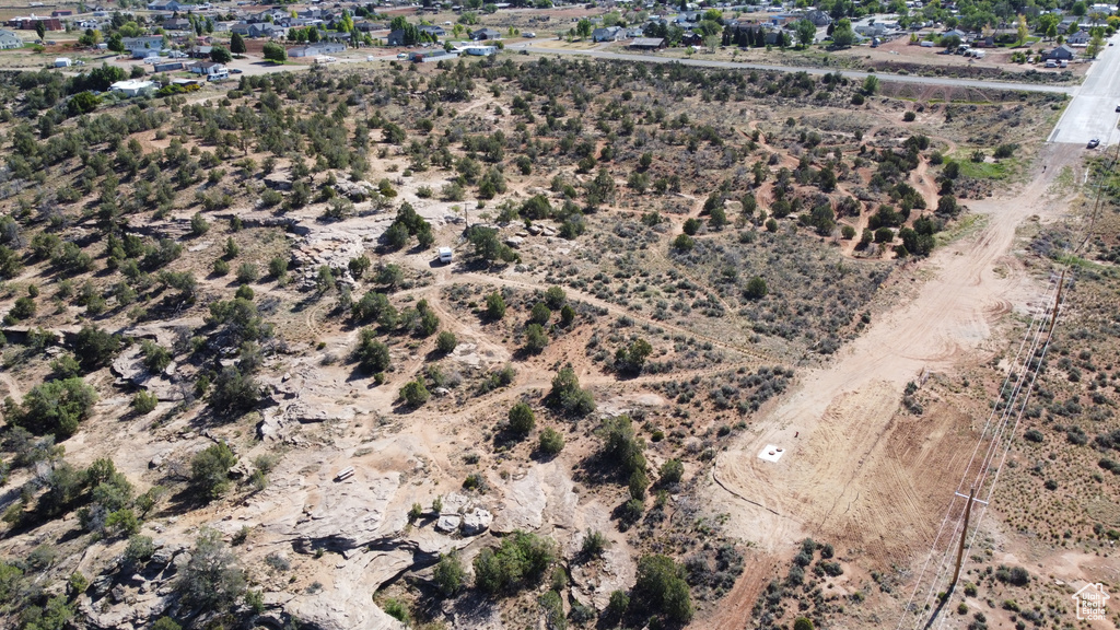 Aerial view of property and surrounding area featuring a desert landscape