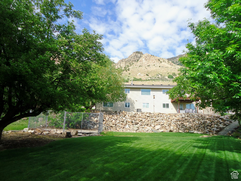 View of grassy yard with a mountain view
