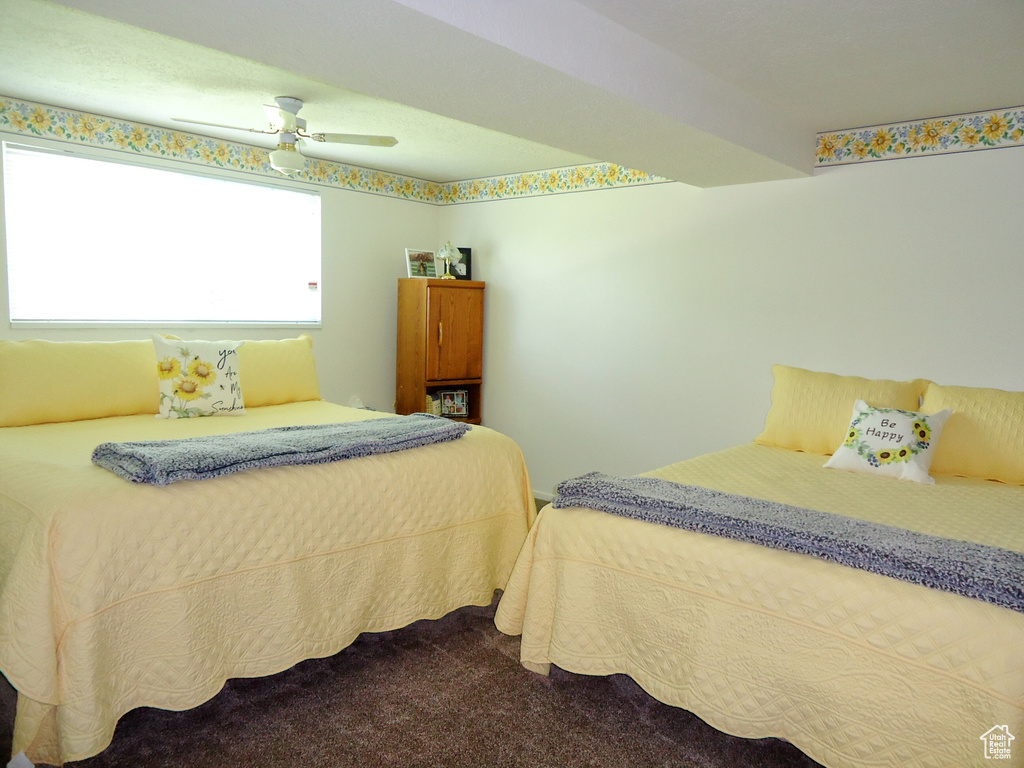 Bedroom with dark carpet and ceiling fan