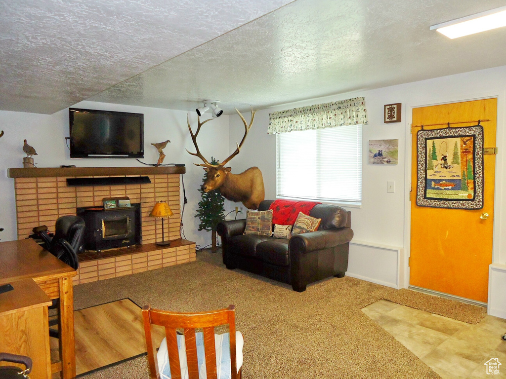 Living room with a textured ceiling and carpet flooring