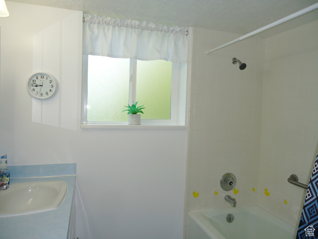 Bathroom with shower / washtub combination and vanity
