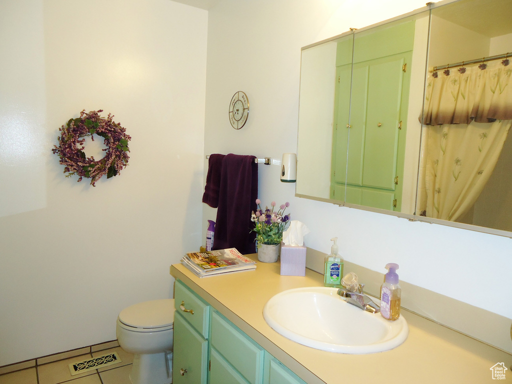 Full bathroom with vanity, tile patterned flooring, and toilet
