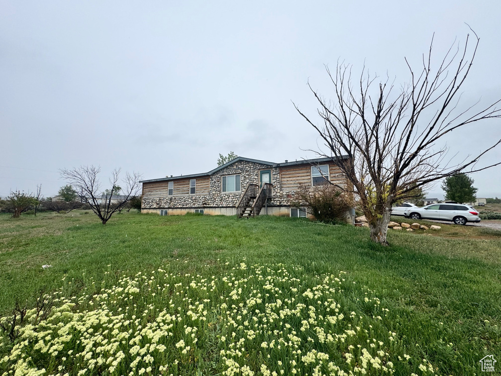 View of property exterior with a yard