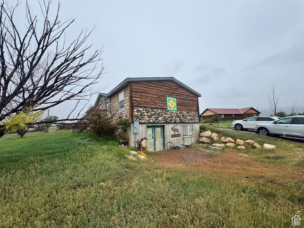 View of side of property featuring a lawn