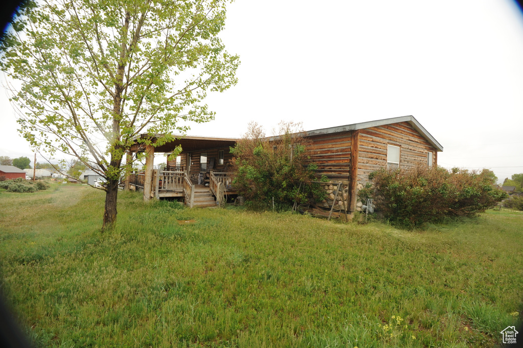 View of front of home with a front lawn and covered porch