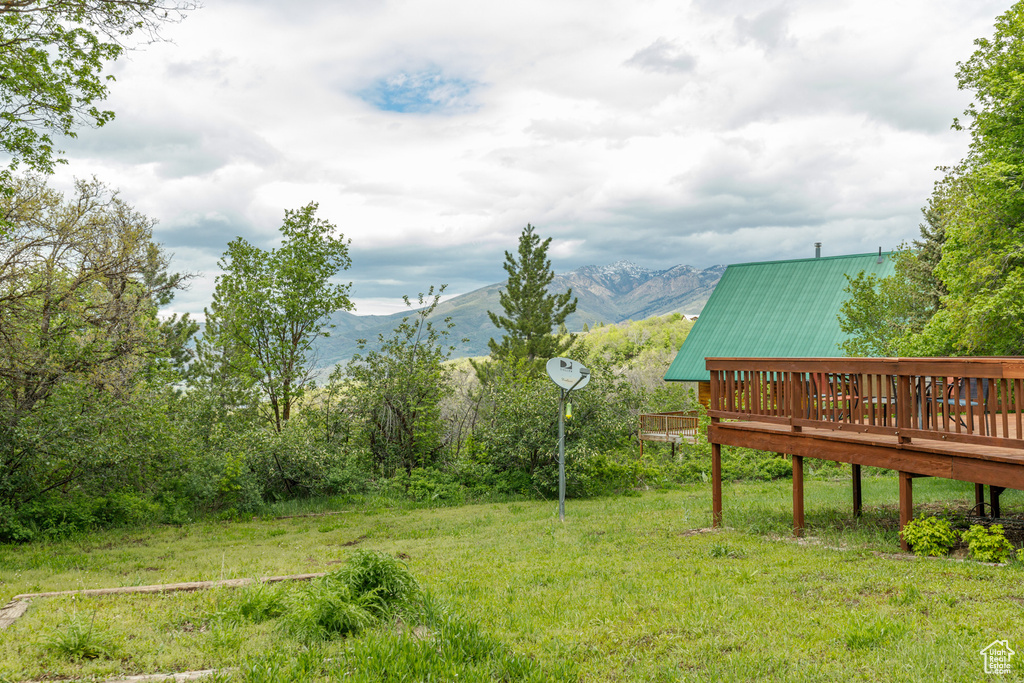 View of yard featuring a deck with mountain view