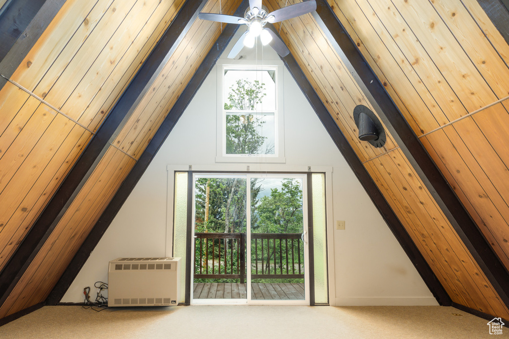 Bonus room with carpet, lofted ceiling, ceiling fan, and heating unit