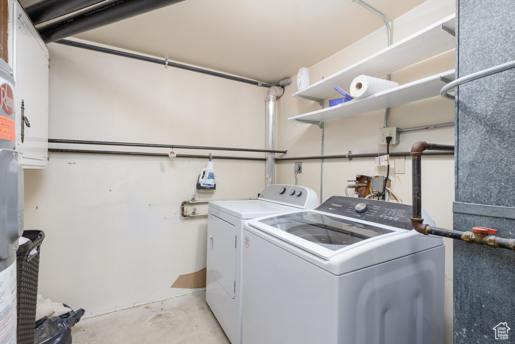 Clothes washing area featuring washing machine and clothes dryer