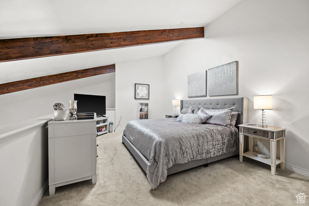 Bedroom with baseboards, light carpet, and vaulted ceiling with beams