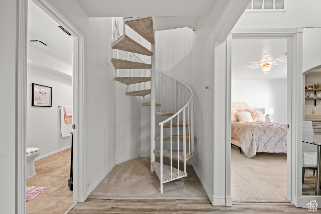 Staircase featuring carpet, baseboards, and visible vents