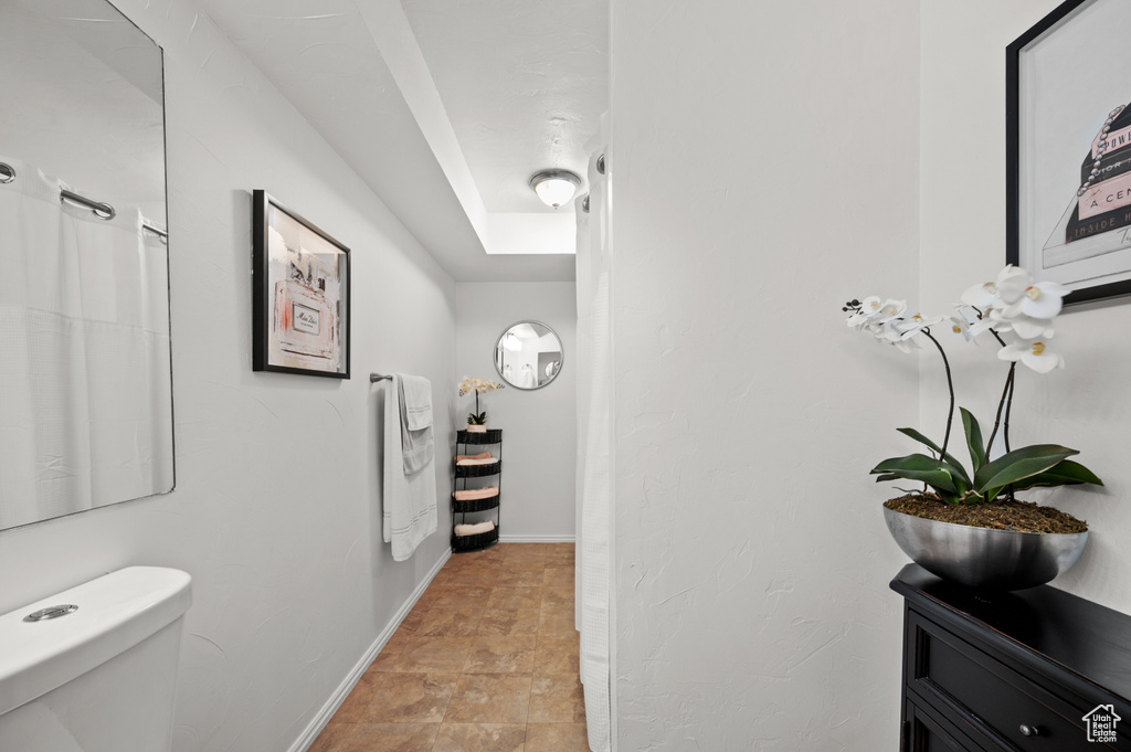 Bathroom featuring toilet and baseboards