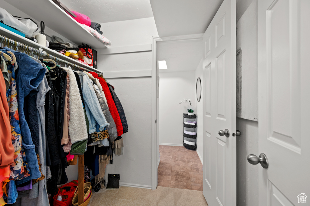 Walk in closet featuring carpet flooring
