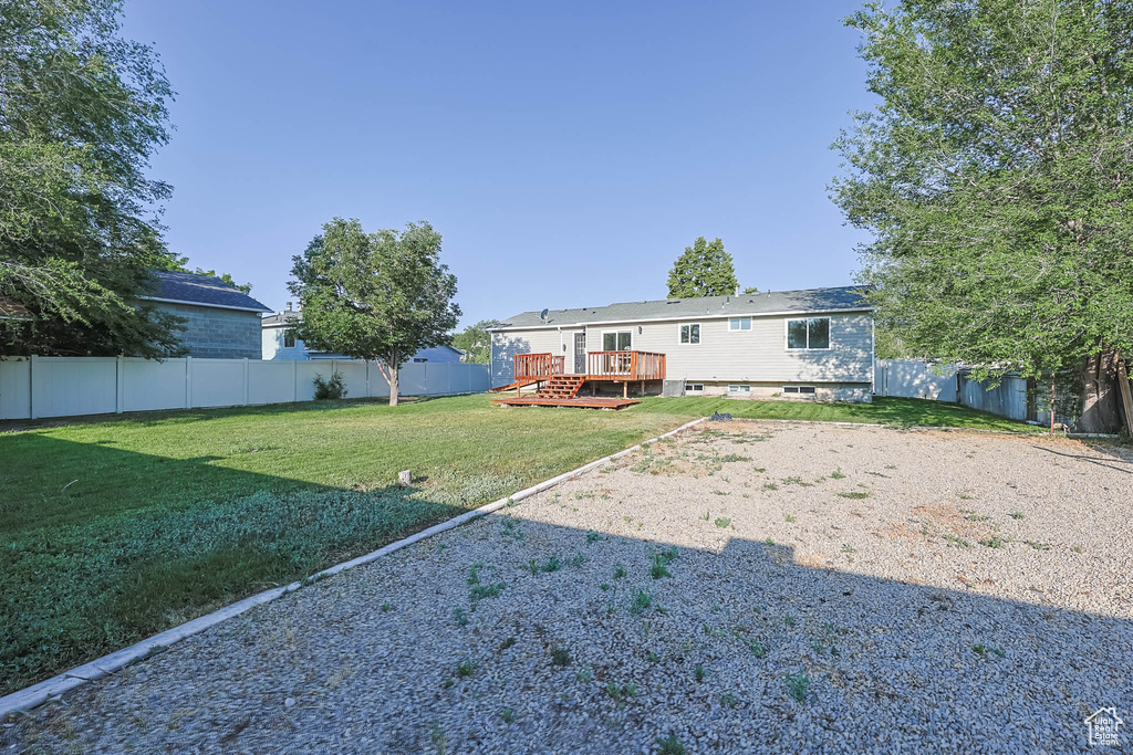 Rear view of property featuring a wooden deck