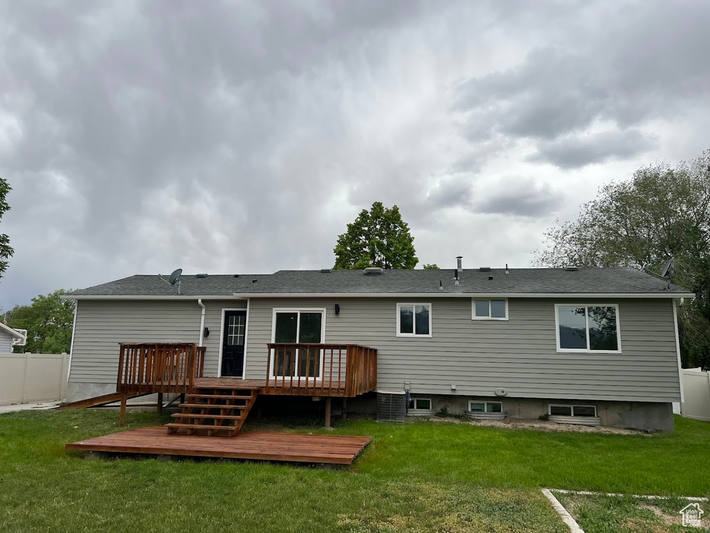 Rear view of house featuring a wooden deck