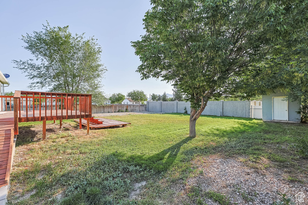 View of yard with a wooden deck