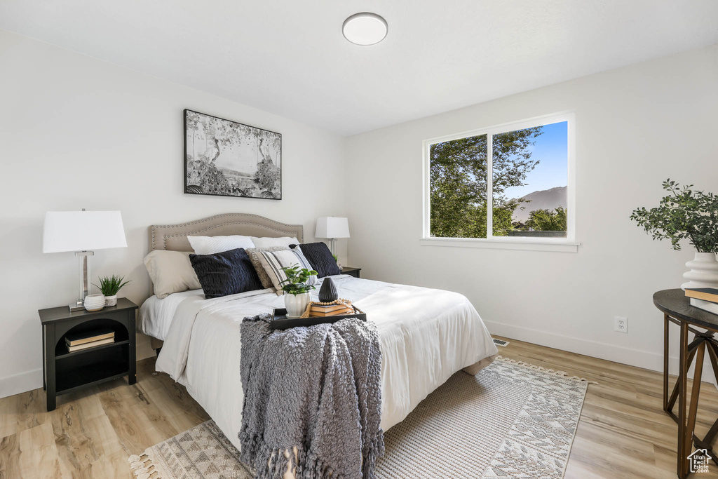 Bedroom with baseboards and light wood-style flooring