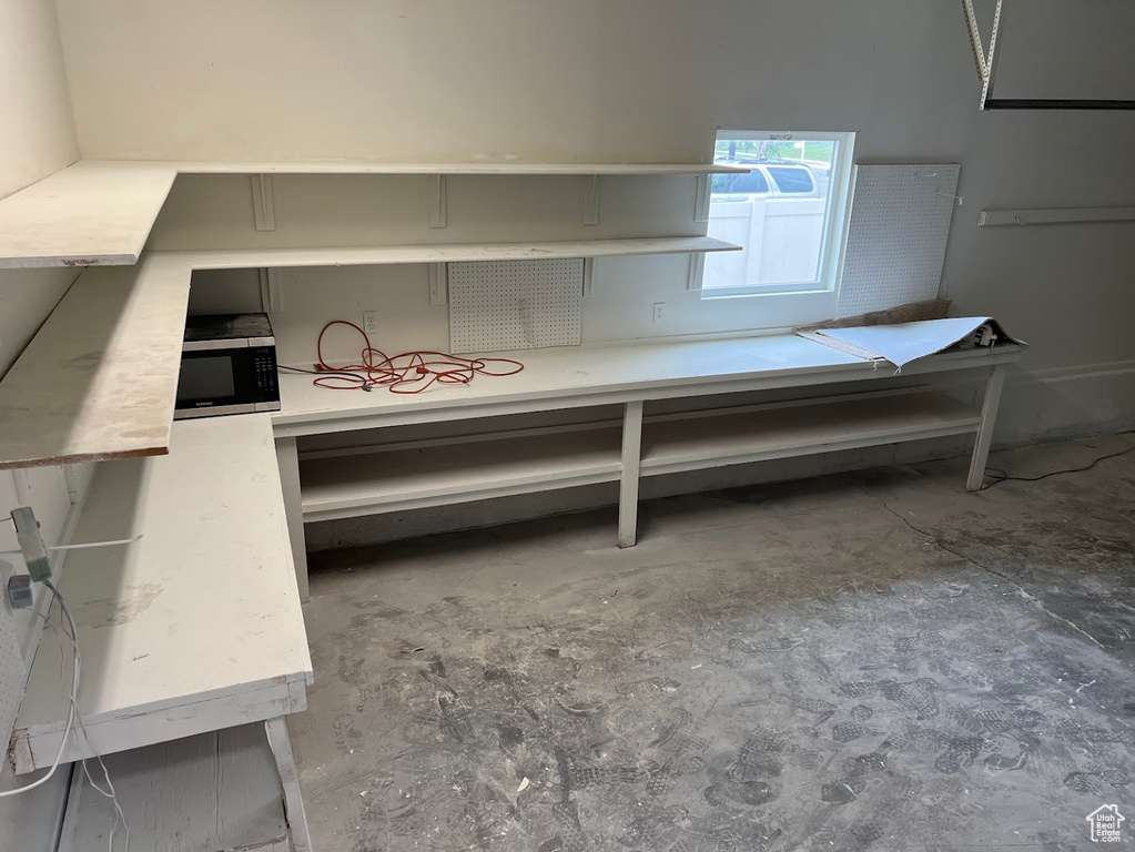 Miscellaneous room with unfinished concrete floors