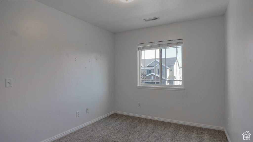 Carpeted empty room with baseboards
