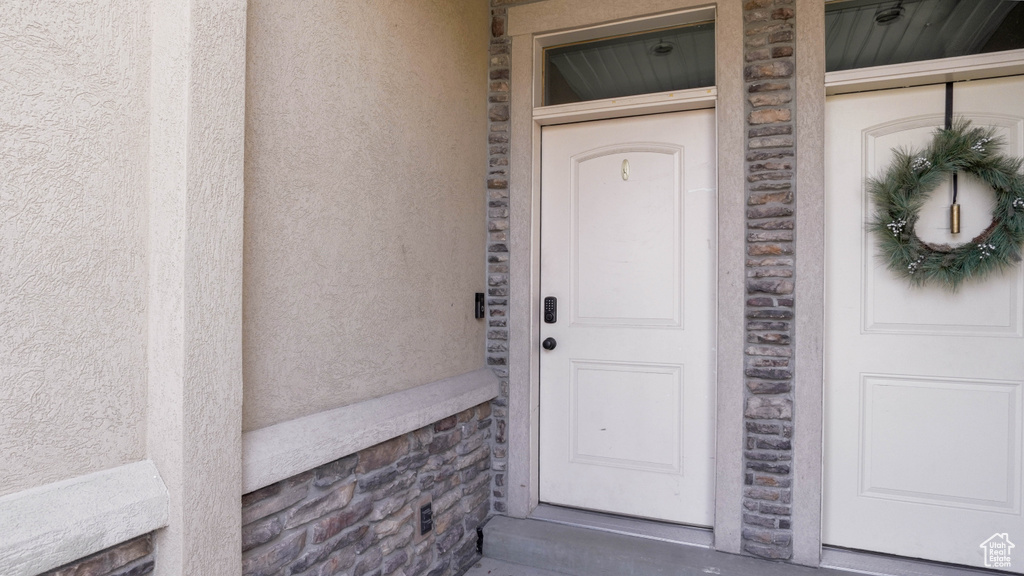 Property entrance with stucco siding