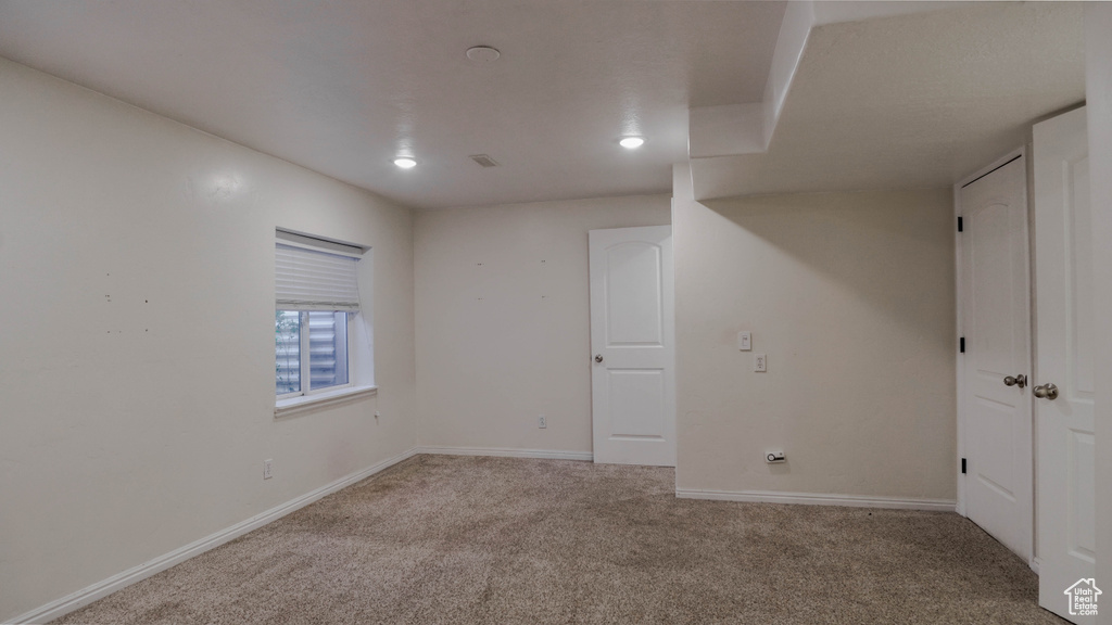 Basement with carpet flooring, baseboards, and recessed lighting