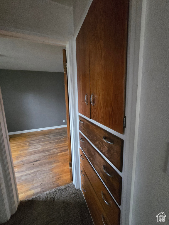 Hall with wood finished floors and baseboards