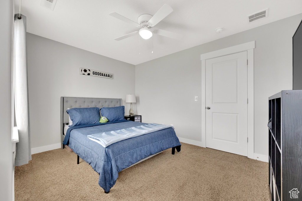 Bedroom featuring carpet, baseboards, and a ceiling fan